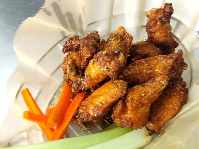 Delicious basket of chicken wings with carrots and celery at Cheers Grille & Bar in Concord NH.
