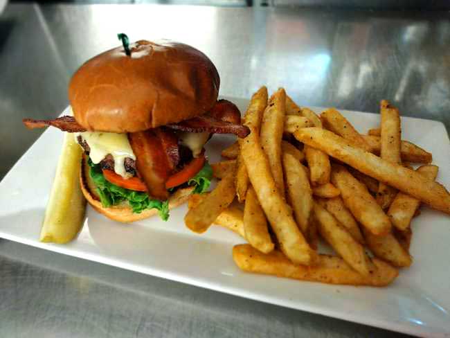Enjoy Concord's best burger! Served with fries at Cheer's Grille & Bar,