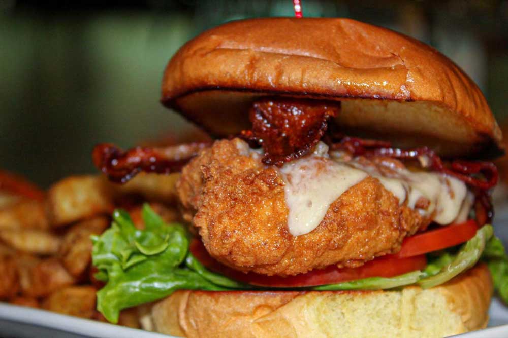 Delicious sandwich served with bacon, lettuce, tomato and cheese on a bun at Cheers Grille & Bar in Concord NH.