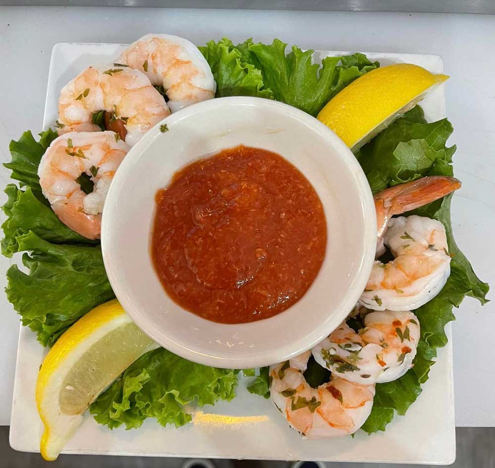 Shrimp cocktail prepared with cocktail sauce and lemons at Cheers Grille & Bar in Concord NH.