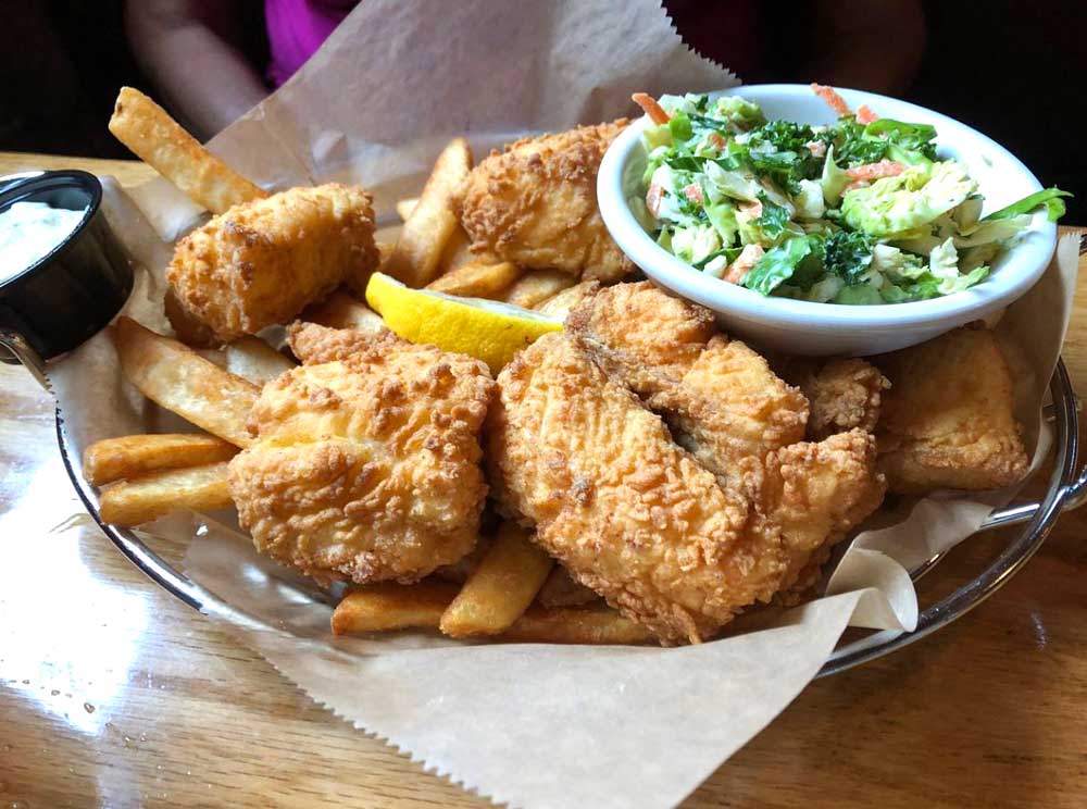 Delicious shrimp breaded and fried to a golden brown served in a basket with fries and coleslaw at Cheers Grille & Bar in Concord NH.