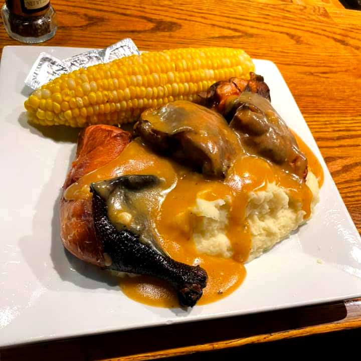 Smoked chicken served over warm mashed potatoes with delicious gravy and buttery corn on the cob at Cheers Grille & Bar in Concord NH.
