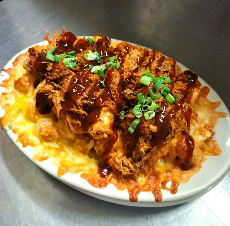 Smothered tots topped with cheese BBQ sauce and more at Cheers Grille & Bar in Concord NH.