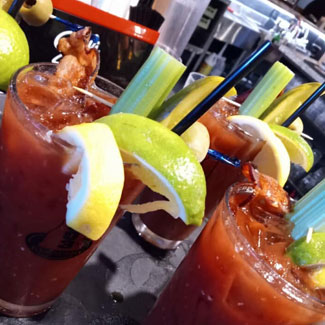 Delicious bloody marys served with bacon, lime celery and more at Cheers Grille & Bar in Concord NH.