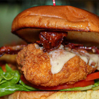 Delicious sandwich served with bacon, lettuce, tomato and cheese on a bun at Cheers Grille & Bar in Concord NH.